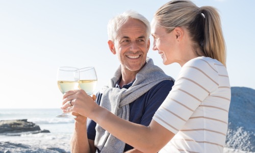 a couple toasting drinks