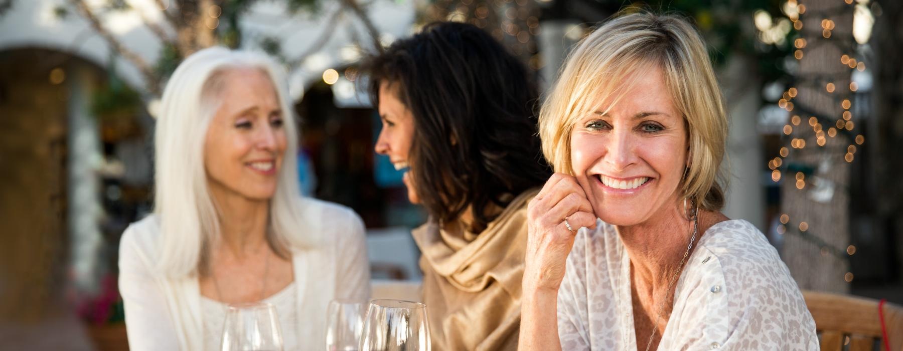 a group of women holding wine glasses